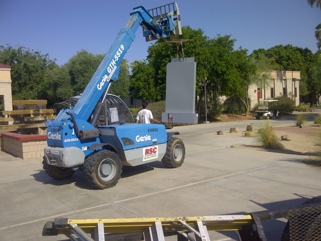 Genie truck lifting a monument sign